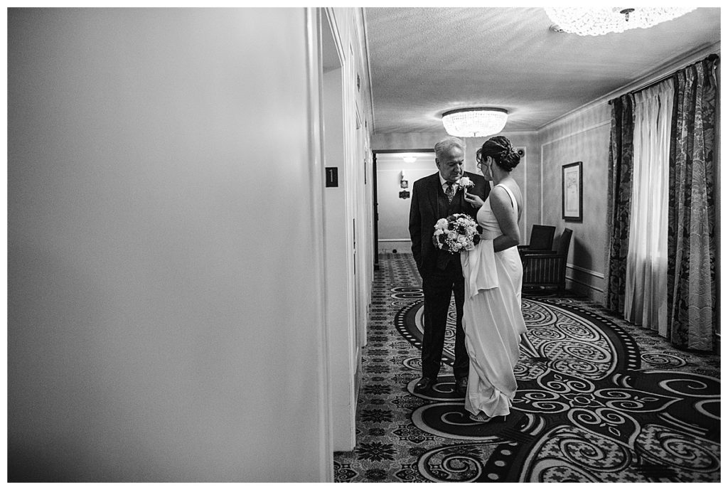 bride and groom wait for elevator together at omni hotel