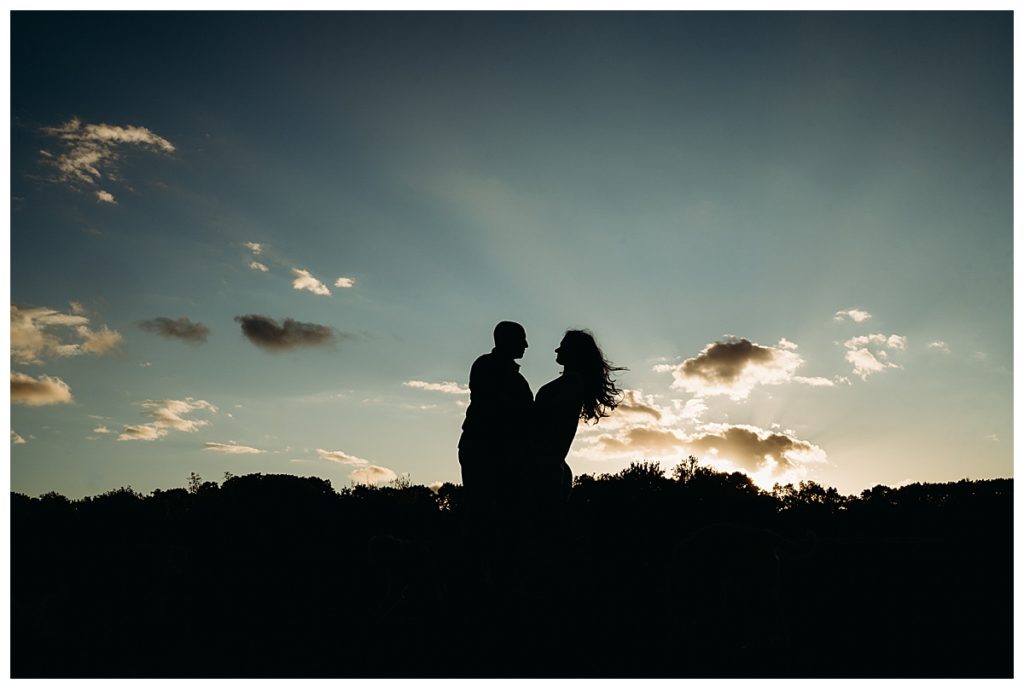 couple in silhouette against a dramatic sky