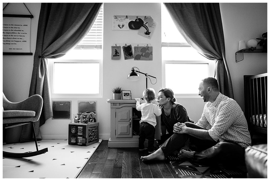 black and white image of parents with toddler in bedroom