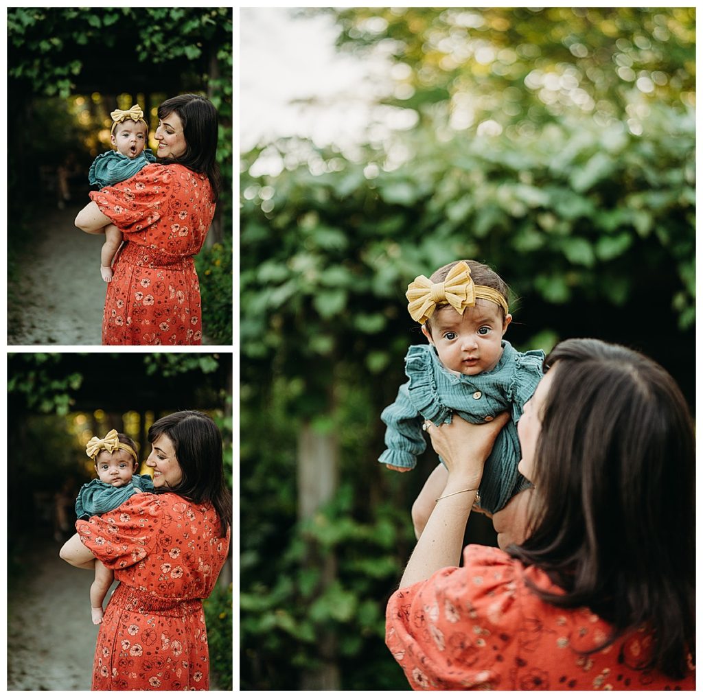 mom holds infant daughter in springtime photo session