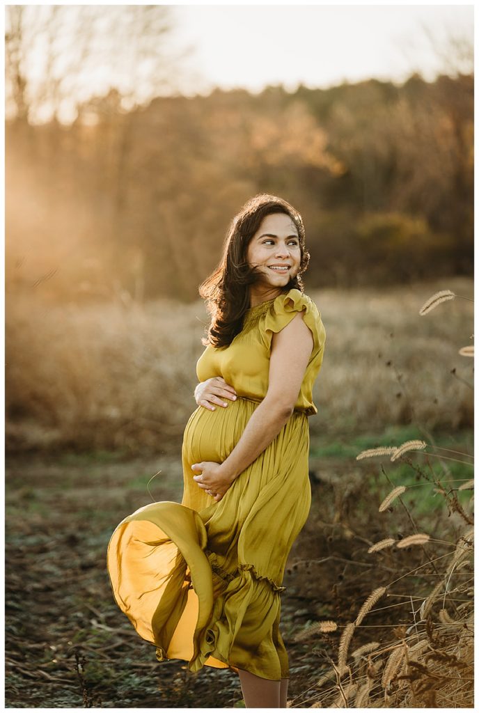 pregnant mother in yellow dress gets photos taken in winter