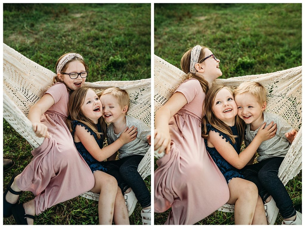 three kids laughing together in a blanket hammock during a family session