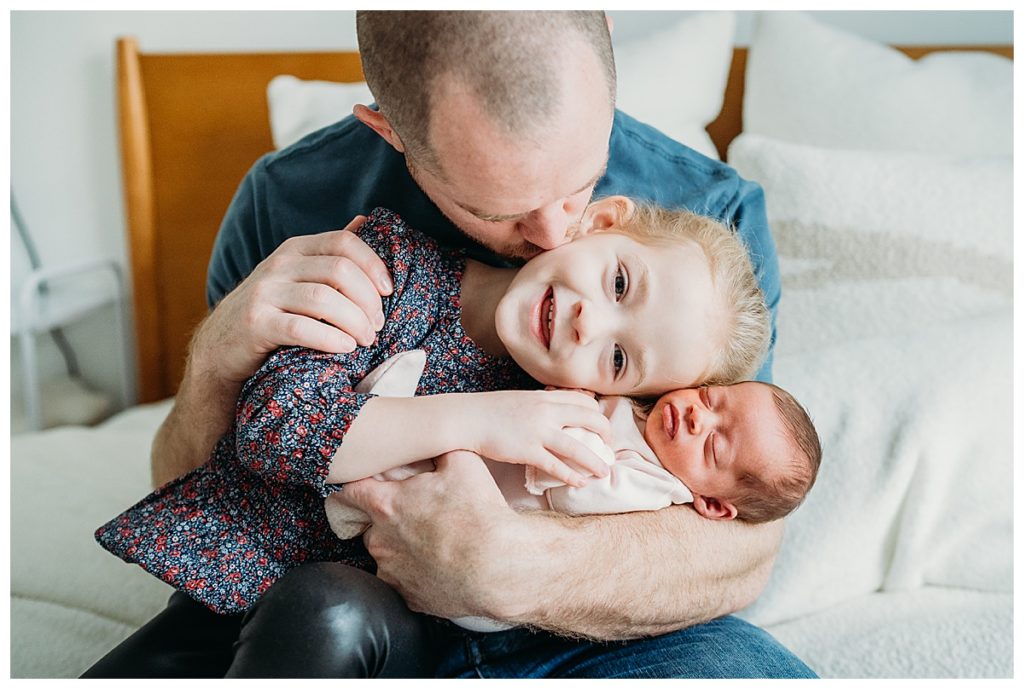dad with two daughters during metro-west newborn photoshoot