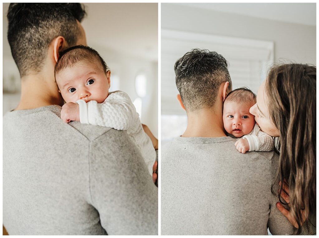 newborn baby looks over dads shoulder during newborn photoshoot