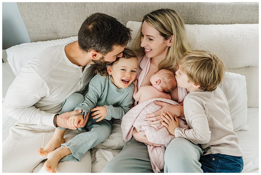 Lifestyle newborn session in Boston home with mother holding sleeping newborn