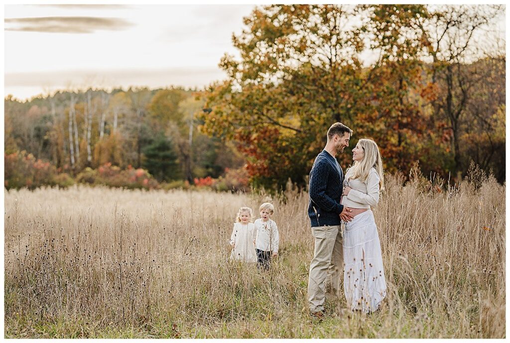 Couple sharing a candid moment during Boston maternity photography session outdoors
